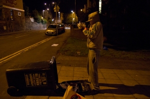 Hoody sets fire to a bin during riots in Bristol